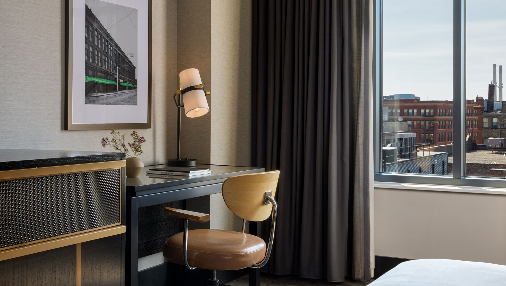 desk, chair and lamp in guestroom at Kimpton Journeyman Hotel