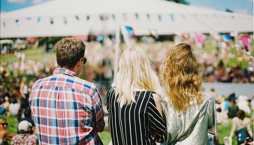 three people at an outdoor concert