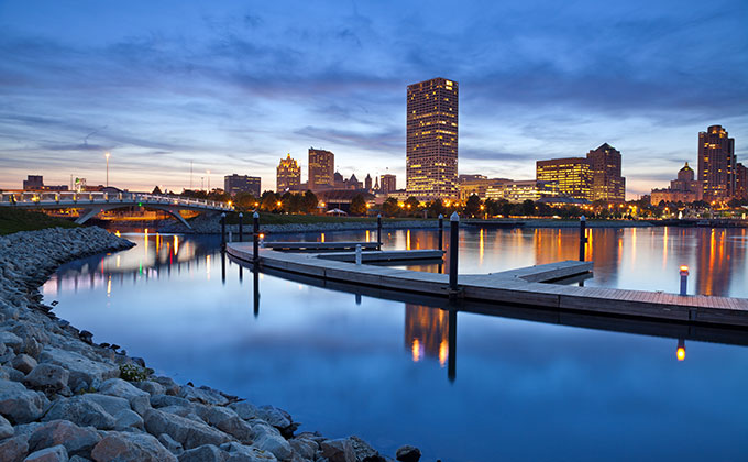 Milwaukee skyline from river bank at dusk